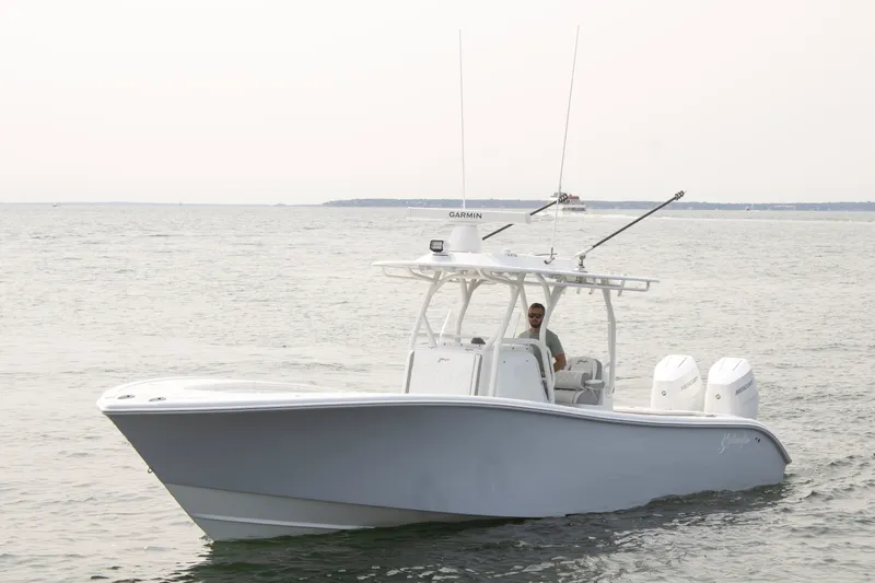  Yacht Photos Pics 2025 Yellowfin 32 Offshore boat on open water, featuring dual engines and sleek design.