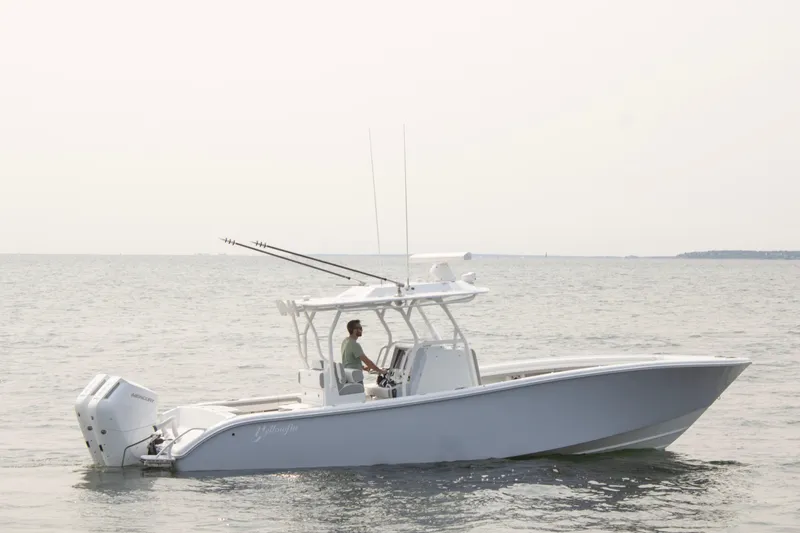  Yacht Photos Pics 2025 Yellowfin 32 Offshore boat cruising on calm waters.