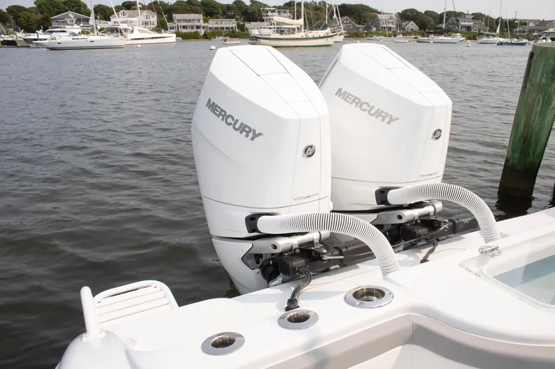  Yacht Photos Pics 2025 Yellowfin 32 Offshore with twin Mercury outboard engines docked by the water.