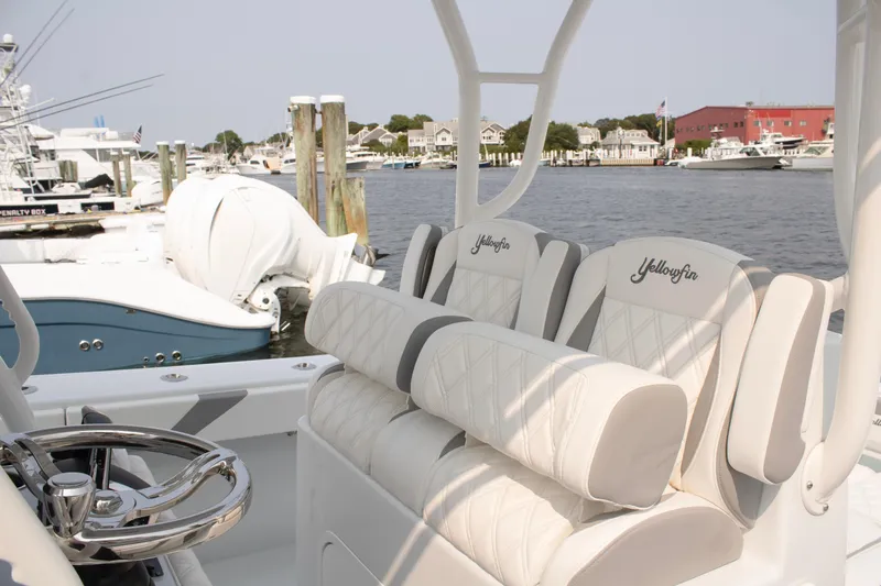  Yacht Photos Pics 2025 Yellowfin 32 Offshore boat interior with luxurious seating at a marina.