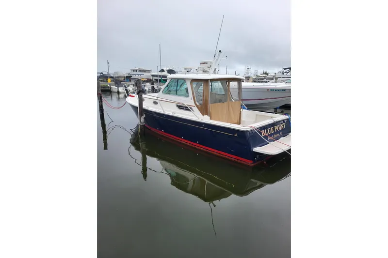  Yacht Photos Pics 2008 Back Cove 29 boat docked in a marina, overcast sky.