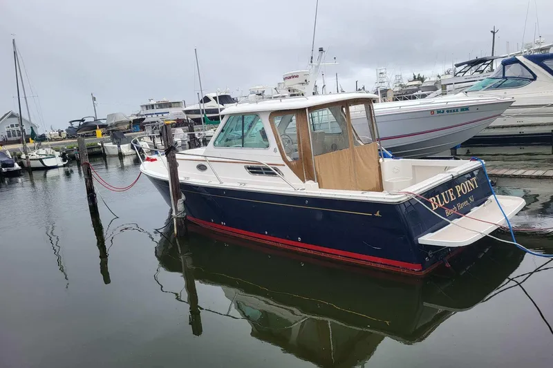  Yacht Photos Pics 2008 Back Cove 29 boat docked in a marina, named "Blue Point."