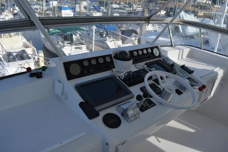 Lady Laura Yacht Photos Pics 1989 Viking Motor Yacht helm with navigation instruments and steering wheel, docked at marina.