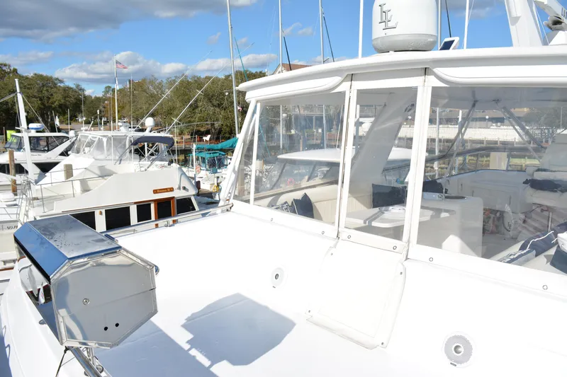 Lady Laura Yacht Photos Pics 1989 Viking Motor Yacht docked at marina under blue sky.