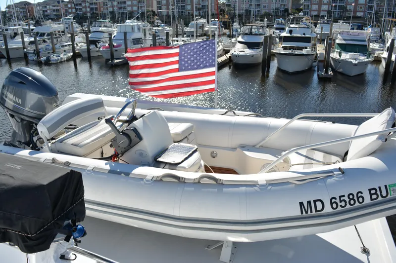 Lady Laura Yacht Photos Pics 1989 Viking Motor Yacht docked with American flag, surrounded by other boats in marina.