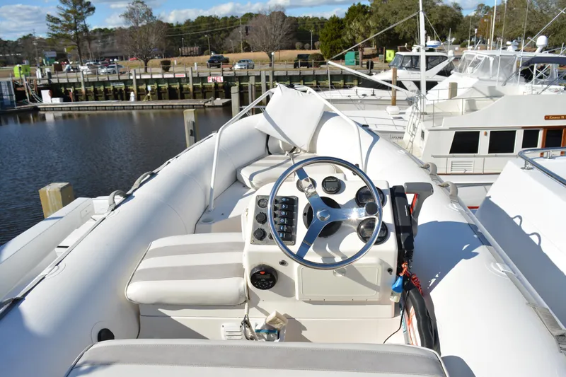 Lady Laura Yacht Photos Pics 1989 Viking Motor Yacht helm with steering wheel and controls, docked at marina.