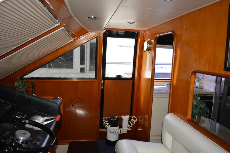 Lady Laura Yacht Photos Pics Interior of 1989 Viking Motor Yacht with wooden paneling and steering wheel.