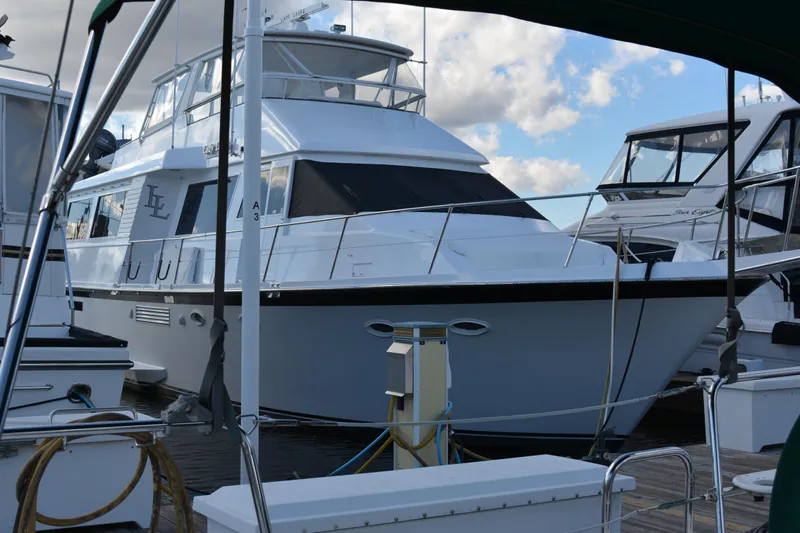 Lady Laura Yacht Photos Pics 1989 Viking Motor Yacht docked at marina under blue sky.