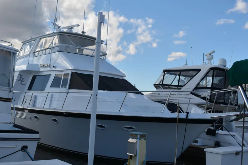 Lady Laura Yacht Photos Pics 1989 Viking Motor Yacht docked at marina under blue sky.