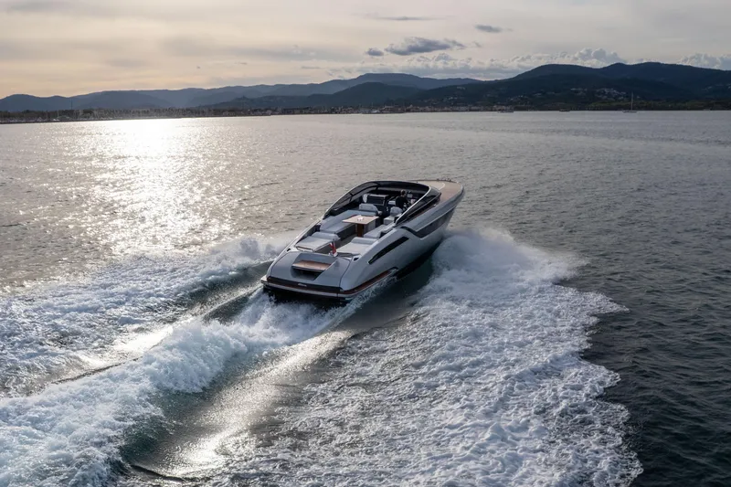  Yacht Photos Pics 2019 Riva Dolceriva 48 yacht cruising on open water at sunset.