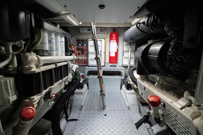  Yacht Photos Pics Engine room of 2019 Riva Dolceriva 48 yacht, featuring mechanical components and fire extinguisher.