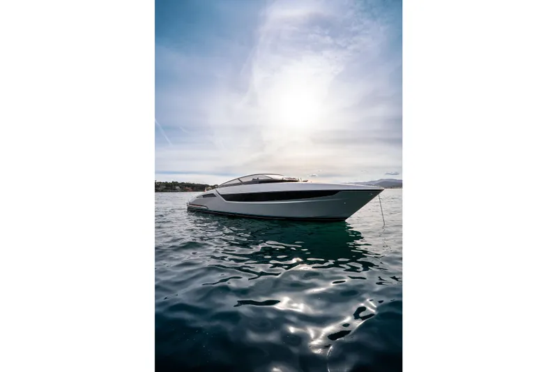  Yacht Photos Pics Luxury Riva Dolceriva 48 yacht on serene water, 2019 model, under a bright sky.