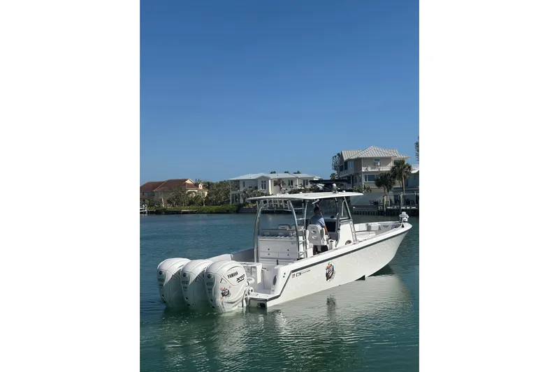  Yacht Photos Pics 2025 Contender 39 ST boat with triple Yamaha engines on calm water.
