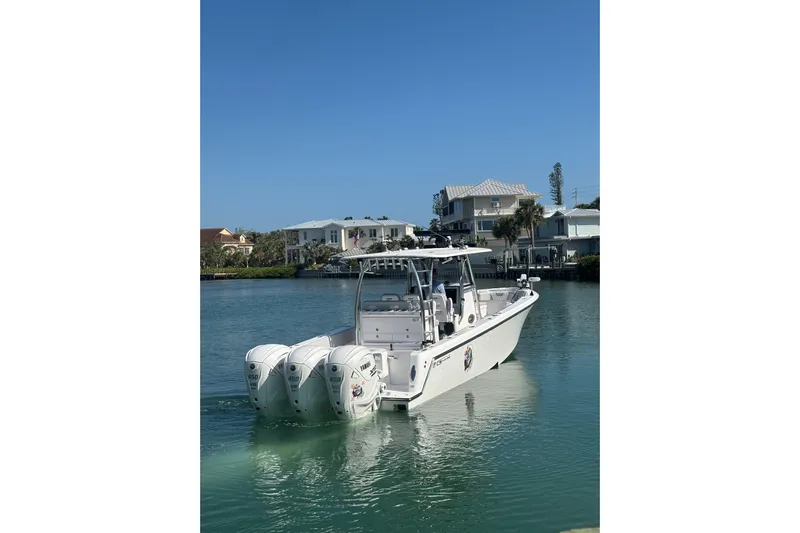  Yacht Photos Pics 2025 Contender 39 ST boat with triple engines on calm water.