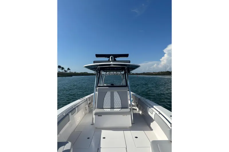  Yacht Photos Pics 2025 Contender 39 ST boat on water, clear sky, coastal view.