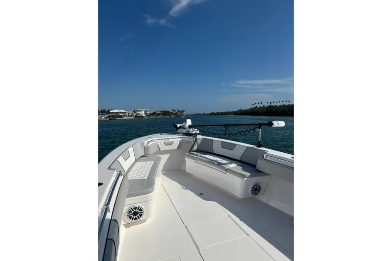  Yacht Photos Pics 2025 Contender 39 ST boat on water, featuring spacious deck and seating.