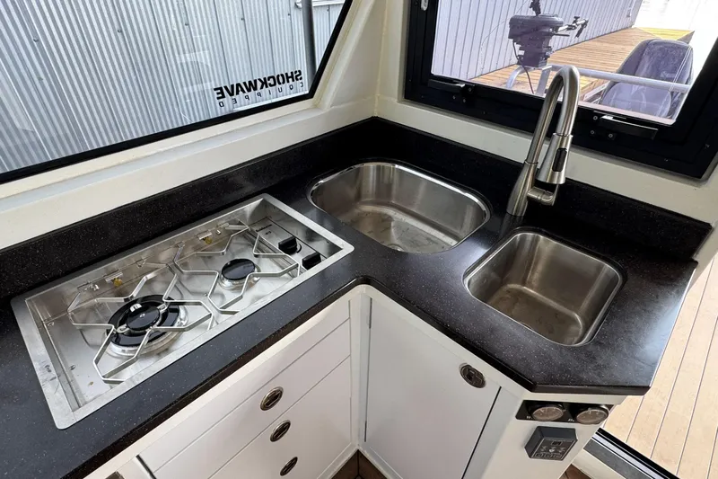  Yacht Photos Pics Modern kitchen in 2025 JR Marine 33 Savage boat with dual sinks and gas stove.