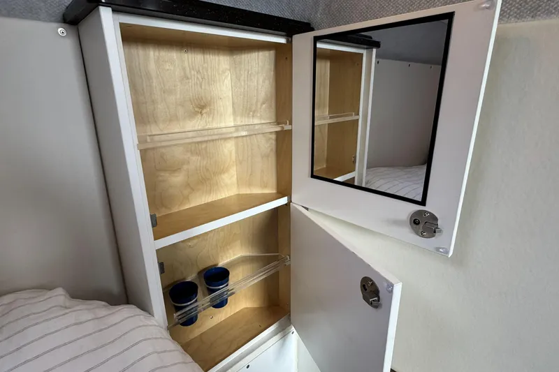  Yacht Photos Pics Open cabinet with mirror in 2025 Custom JR Marine 33 Savage boat interior.