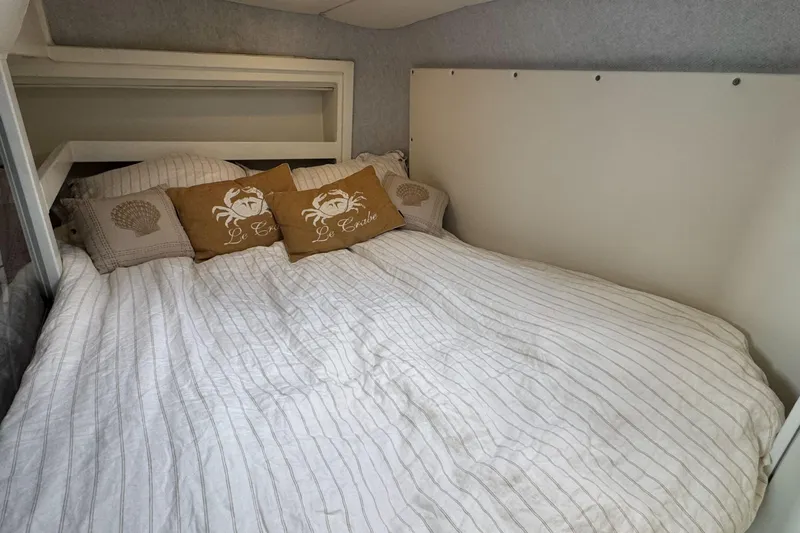  Yacht Photos Pics Cozy bedroom in 2025 Custom JR Marine 33 Savage boat with nautical-themed pillows.