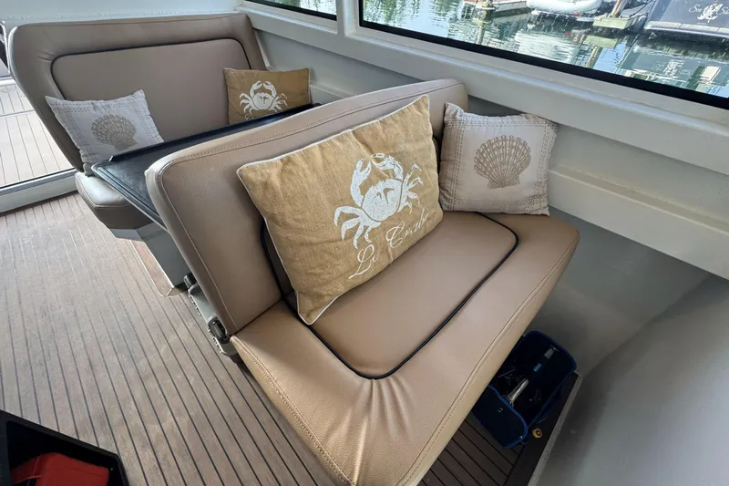  Yacht Photos Pics Luxurious seating with nautical-themed pillows on a 2025 Custom JR Marine 33 Savage boat.