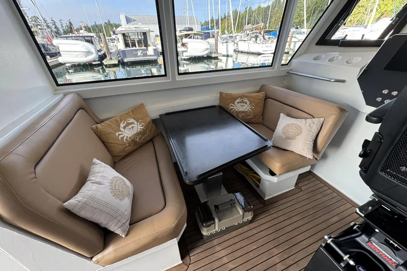  Yacht Photos Pics Interior of 2025 Custom JR Marine 33 Savage boat with cozy seating and nautical decor.