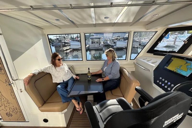  Yacht Photos Pics Interior of 2025 Custom JR Marine 33 Savage boat with two people relaxing.