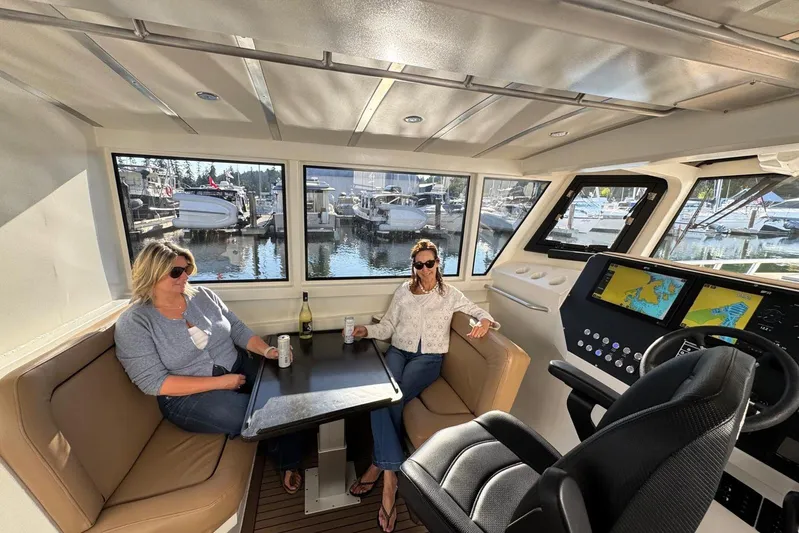  Yacht Photos Pics Interior of 2025 Custom JR Marine 33 Savage boat with two people relaxing.