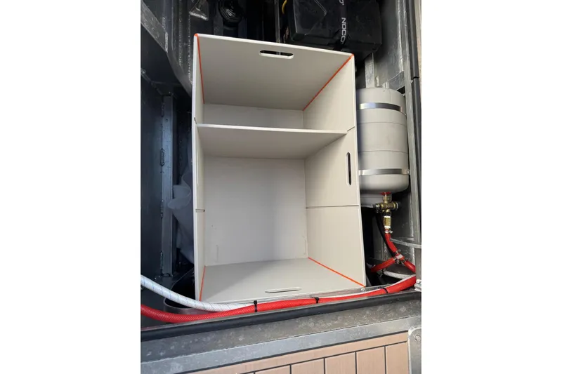  Yacht Photos Pics Storage compartment in 2025 JR Marine 33 Savage boat, featuring organized shelves and equipment.