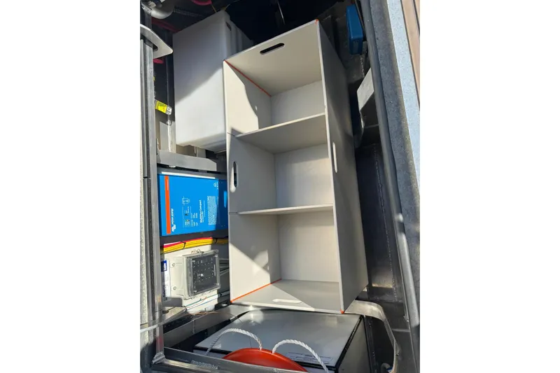  Yacht Photos Pics Interior view of 2025 JR Marine 33 Savage boat storage compartment with shelves and equipment.