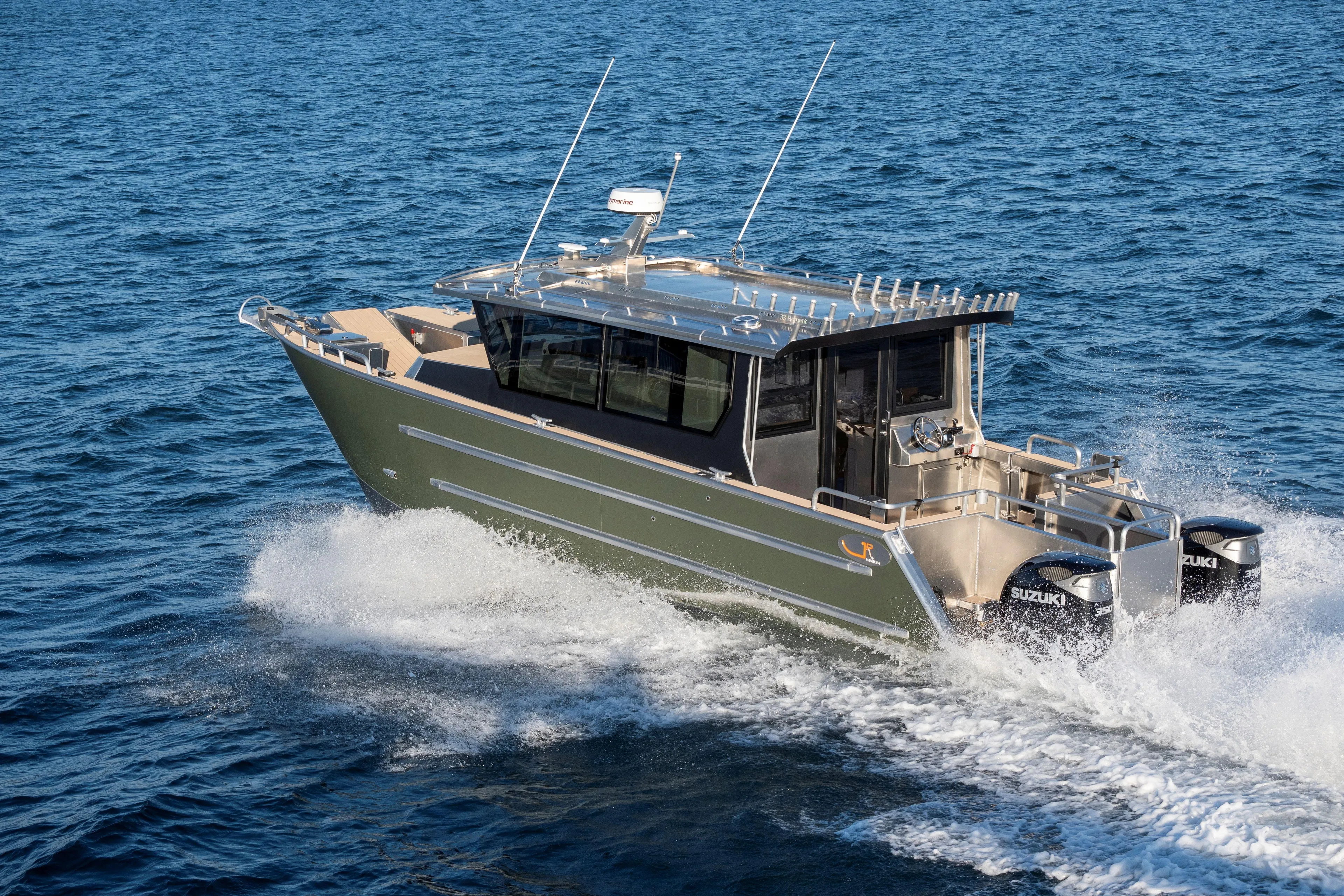  Yacht Photos Pics 2025 JR Marine 33 Savage boat cruising on open water, featuring dual Suzuki engines.