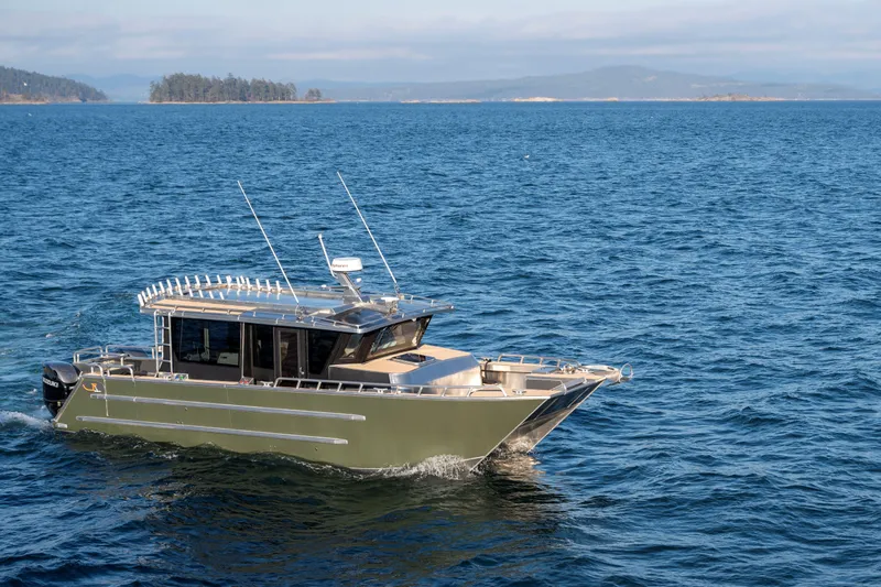  Yacht Photos Pics 2025 JR Marine 33 Savage boat cruising on open water with scenic island backdrop.