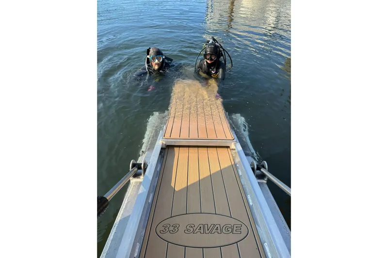  Yacht Photos Pics Divers near JR Marine 33 Savage boat, 2025 model, in water.
