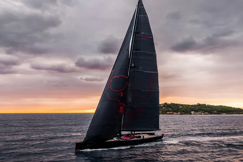 Black Sails Yacht Photos Pics Sleek 2009 Wally 130 yacht sailing at sunset with dramatic skies.