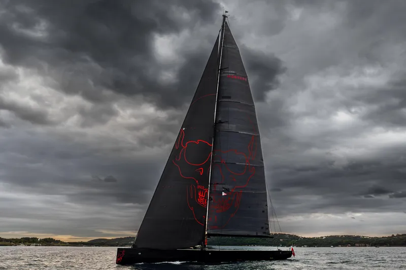 Black Sails Yacht Photos Pics Sleek Wally 130 yacht with skull design sails under dramatic cloudy sky, 2009 model.