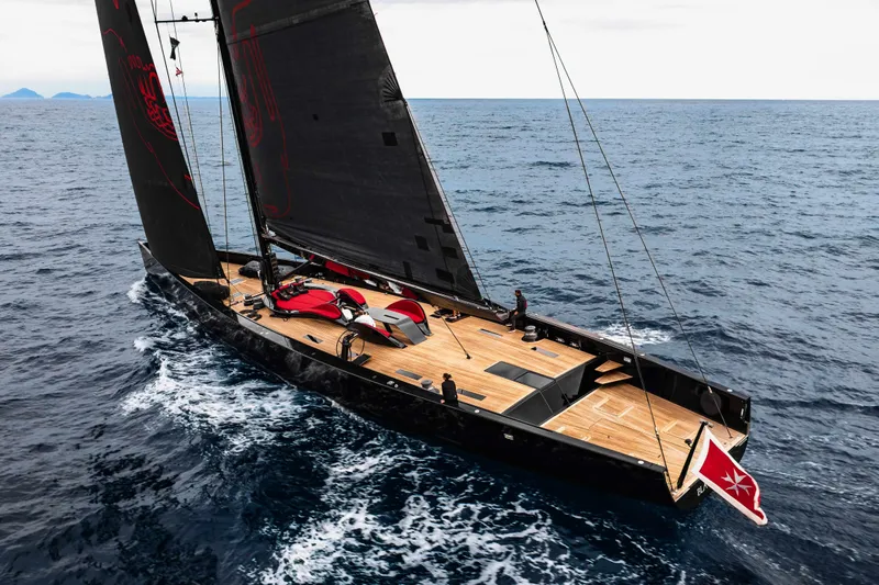 Black Sails Yacht Photos Pics Sleek Wally 130 yacht sailing on open sea, featuring modern design and black sails.