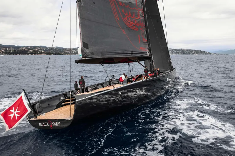 Black Sails Yacht Photos Pics Sleek 2009 Wally 130 yacht sailing with black sails on open sea.