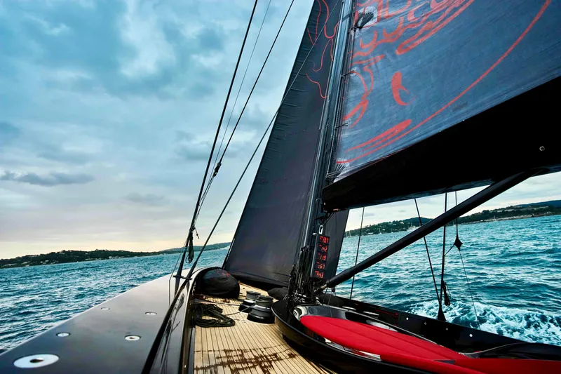 Black Sails Yacht Photos Pics Sailing on a 2009 Wally 130 yacht with sleek black sails and vibrant ocean backdrop.