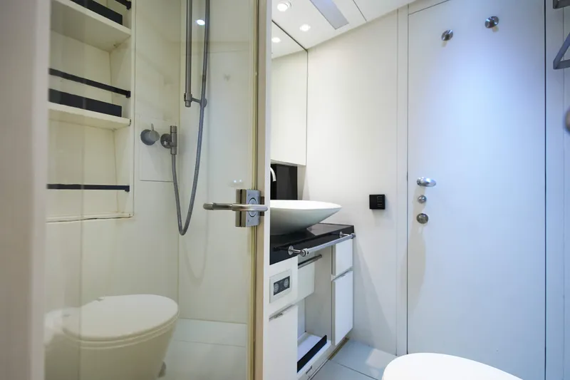 Black Sails Yacht Photos Pics Modern yacht bathroom with sleek design, featuring a shower, sink, and storage shelves. Wally 130, 2009.