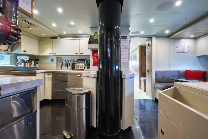 Black Sails Yacht Photos Pics Luxurious yacht kitchen interior with modern appliances, sleek countertops, and cozy seating area. Wally 130, 2009.