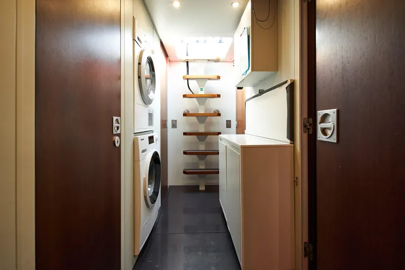 Black Sails Yacht Photos Pics Laundry room on 2009 Wally 130 yacht with washer, dryer, and wooden steps.