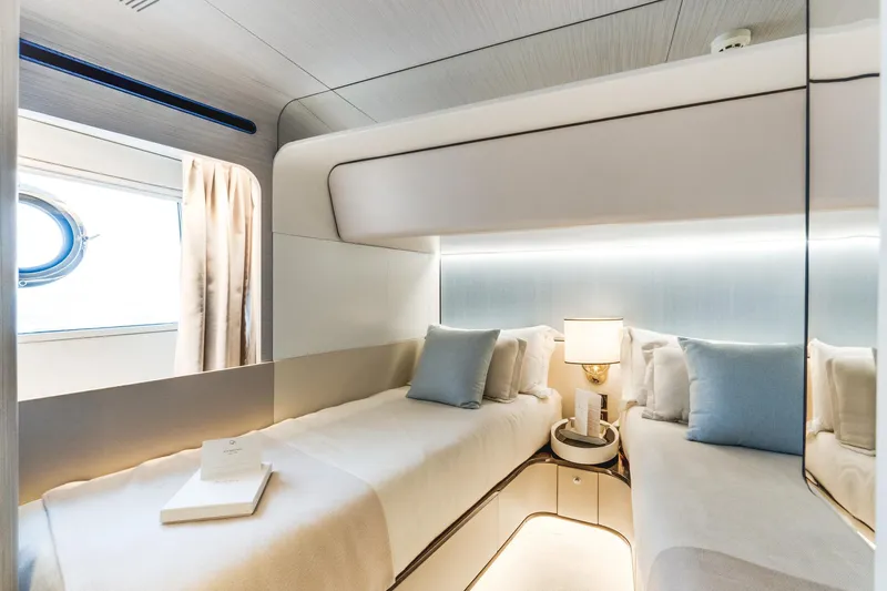  Yacht Photos Pics Luxurious cabin interior of 2019 Azimut 27 Metri yacht with twin beds and elegant decor.