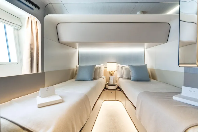  Yacht Photos Pics Luxurious twin cabin interior of 2019 Azimut 27 Metri yacht, featuring elegant design and soft lighting.