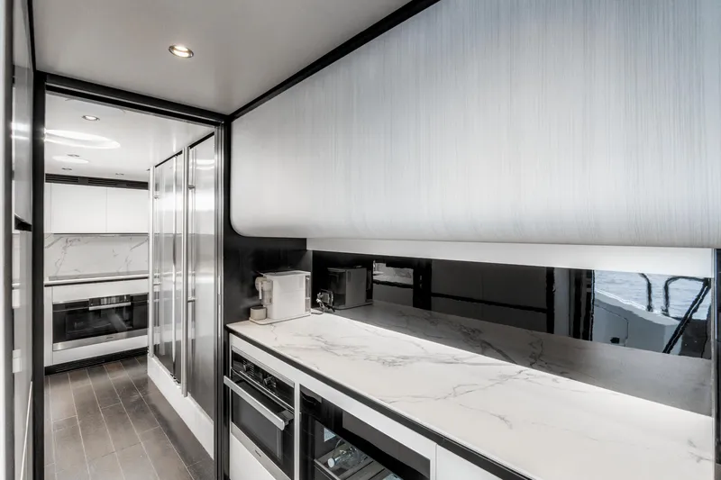  Yacht Photos Pics Luxurious kitchen interior of 2019 Azimut 27 Metri yacht with modern appliances.