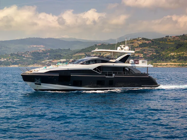  Yacht Photos Pics Luxurious 2019 Azimut 27 Metri yacht cruising on scenic coastal waters.