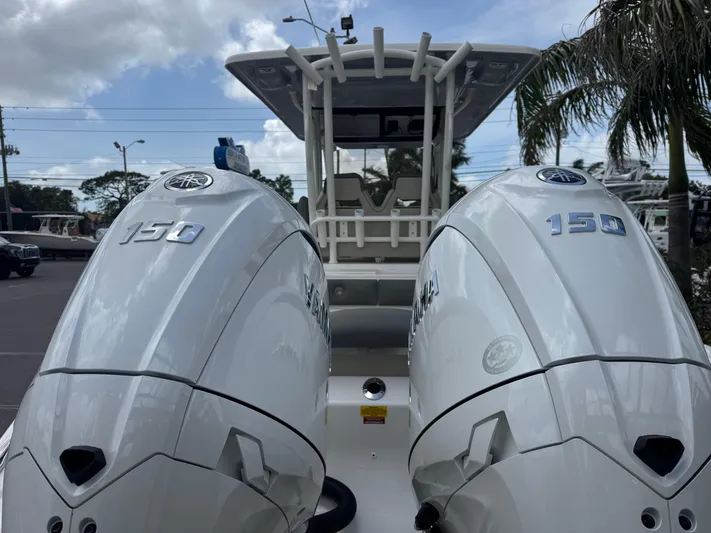  Yacht Photos Pics 2025 Key West 260 boat with dual 150 horsepower engines, docked under a cloudy sky.