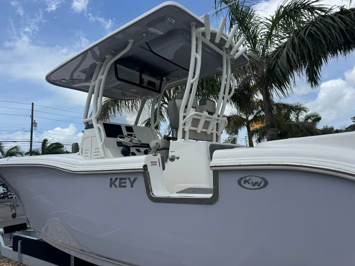  Yacht Photos Pics 2025 Key West 260 boat with T-top, palm trees in background.