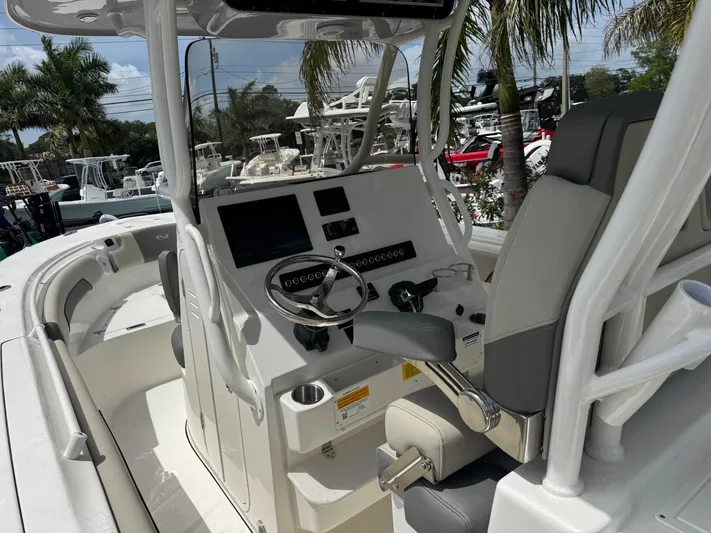  Yacht Photos Pics 2025 Key West 260 boat interior with steering console, modern controls, and seating.