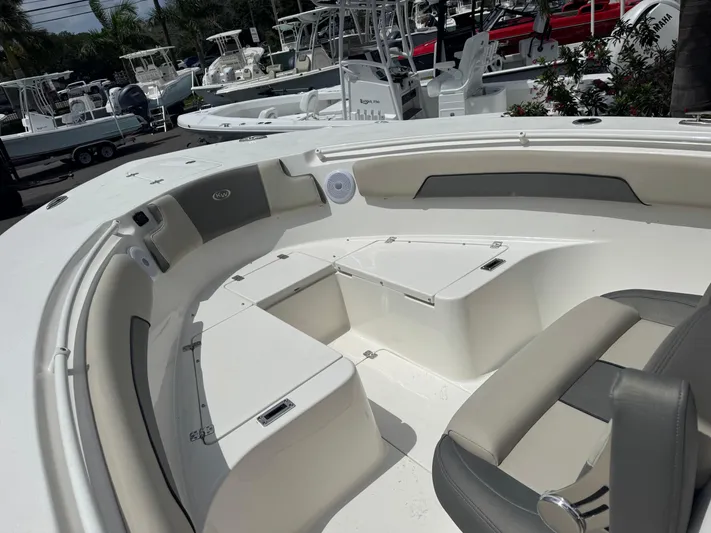  Yacht Photos Pics 2025 Key West 260 boat interior with seating and storage, docked among other boats.