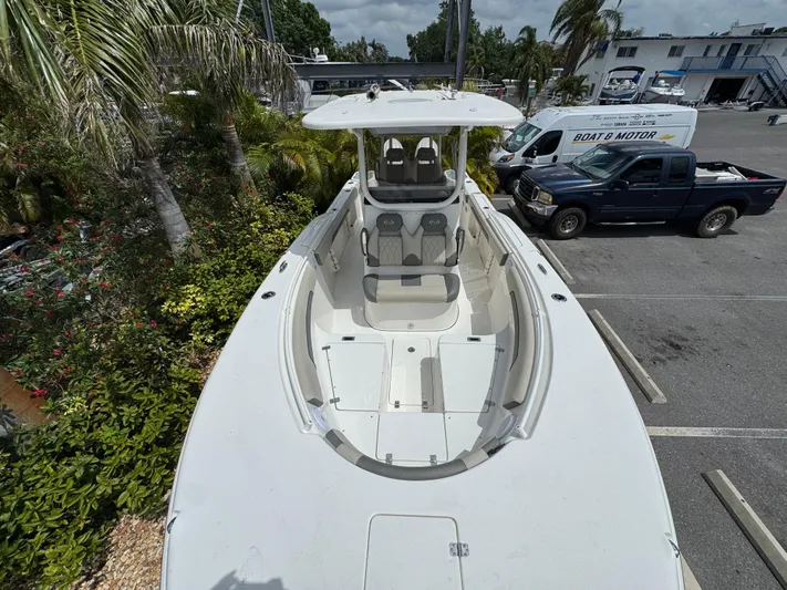  Yacht Photos Pics 2025 Key West 260 boat, aerial view, parked near tropical foliage and vehicles.