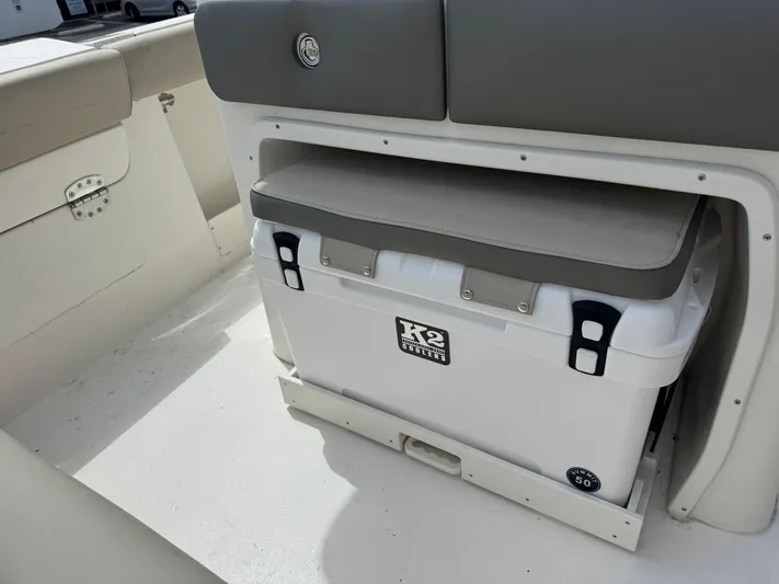  Yacht Photos Pics 2025 Key West 260 boat interior with cooler storage under cushioned seat.